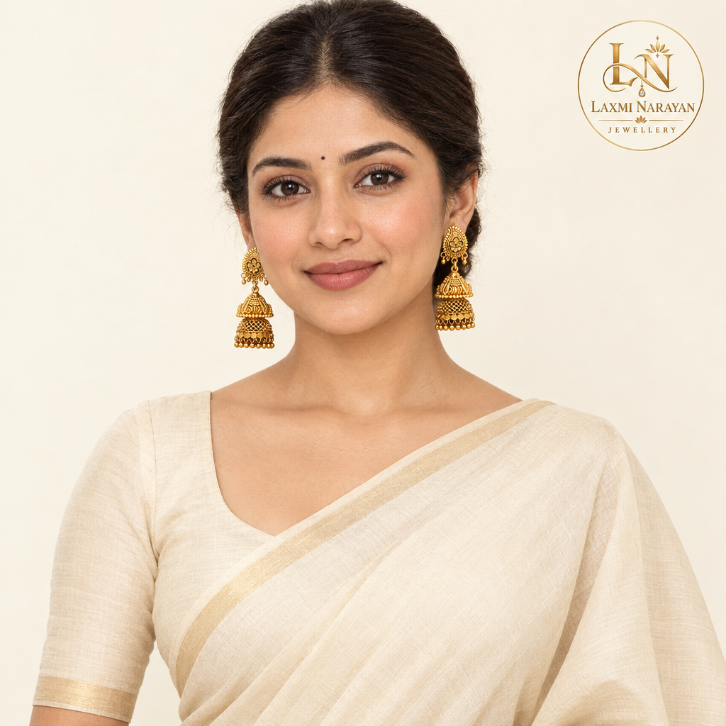 Standing model wearing floral jhumka earrings with Laxmi Narayan Jewellery logo