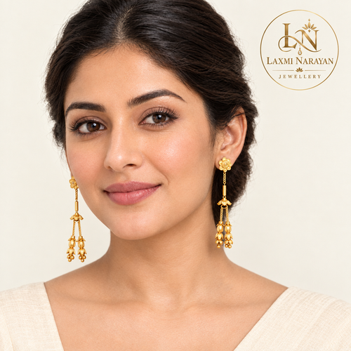 Model wearing floral earrings with two hanging strands